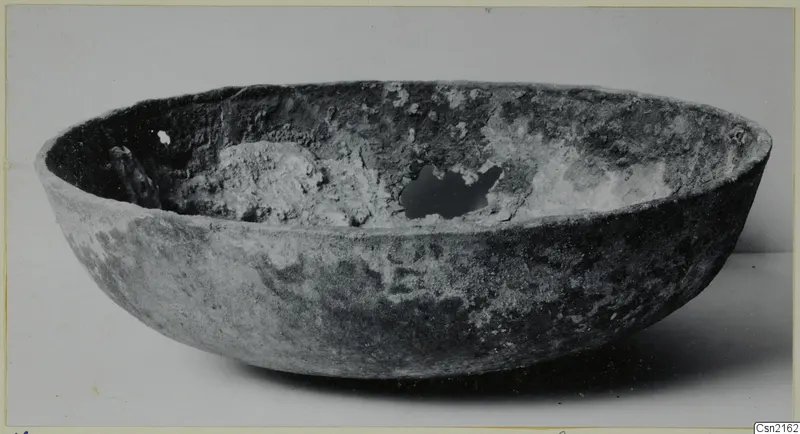 Bowl from Marion with a crusted interior, photographed on a pale surface