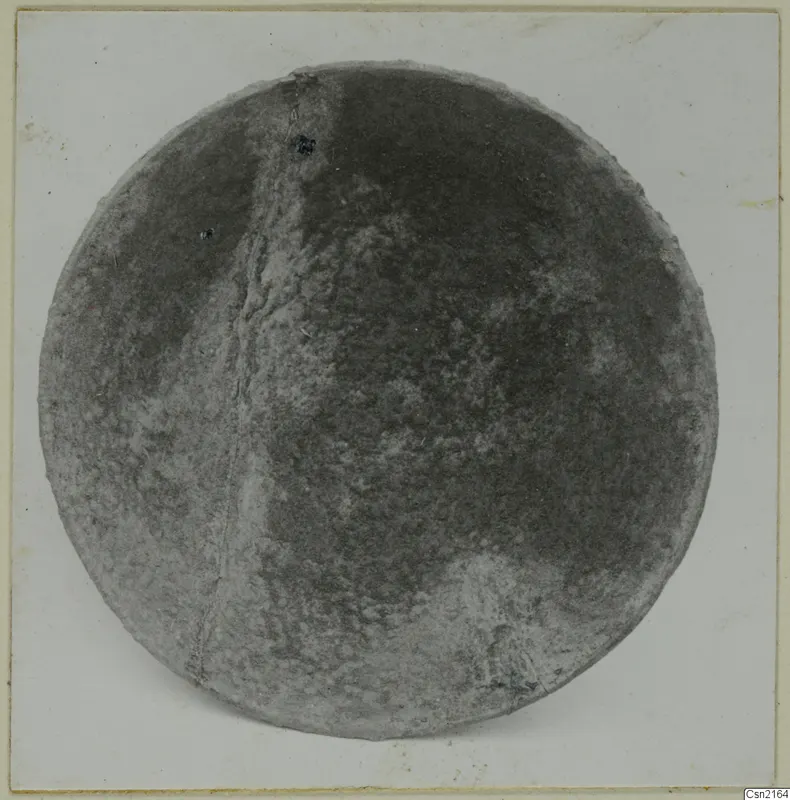 Bowl seen from above, with a mottled grey surface and a crack running down one side.