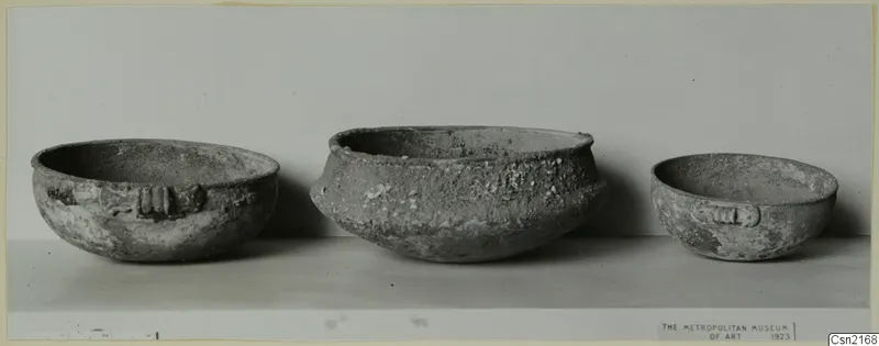 Three bowls of different sizes standing in a row, two with ridged handles