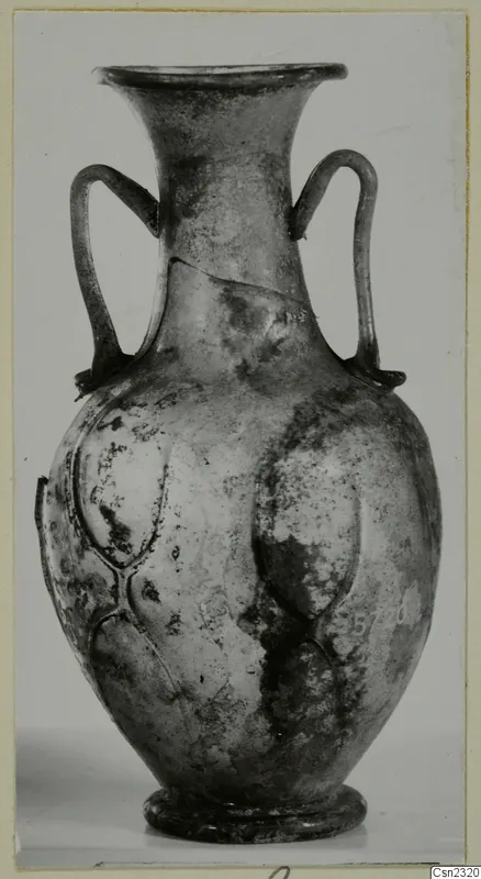 Small blown glass two-handled vessel with a pattern of raised lobes on the body.