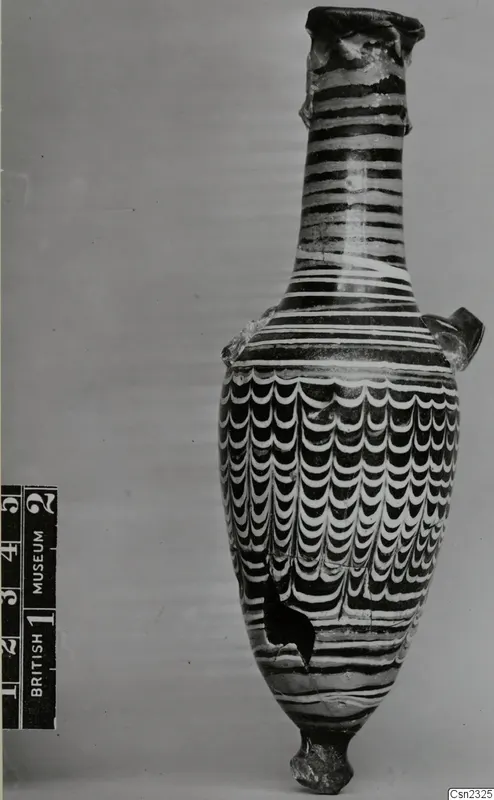 Sand-core glass vessel with a long neck, two small handles and white and dark trailed decoration