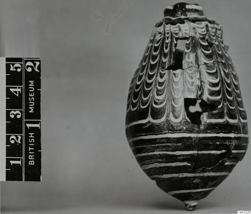 Sand-core glass vessel with white feathered and banded trails, neck broken away