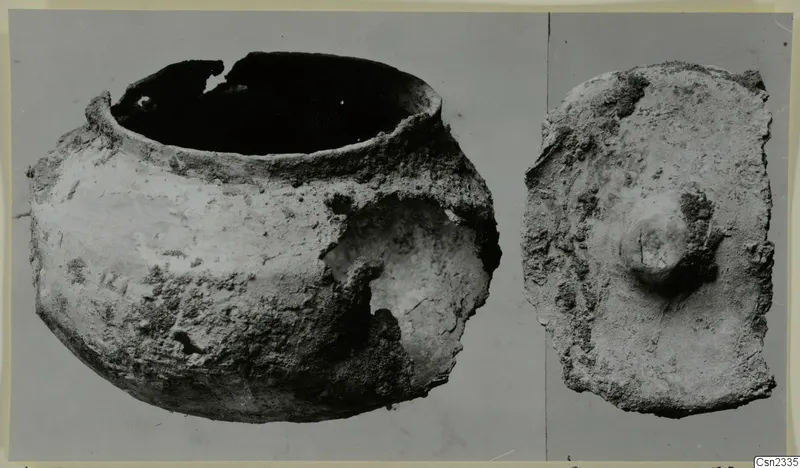 Corroded lead container and its lid from Marion, photographed side by side on a grey background