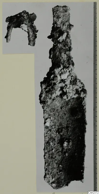 Two corroded iron tools, one long with a narrow upper end, the other a small bent fragment.