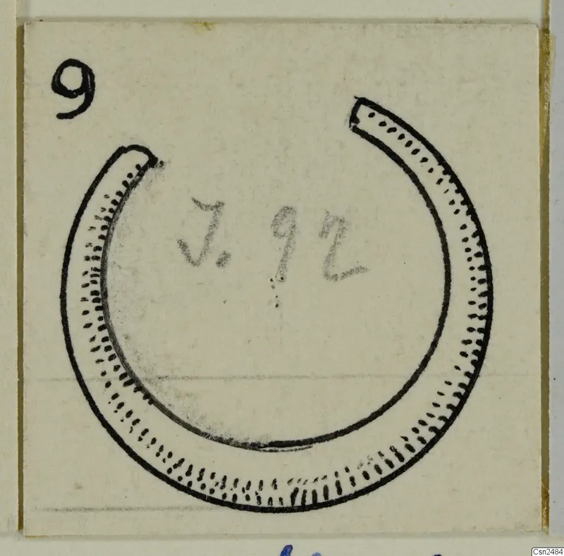 Drawing of an open ring-shaped ornament with dotted and dashed edges on a pale card