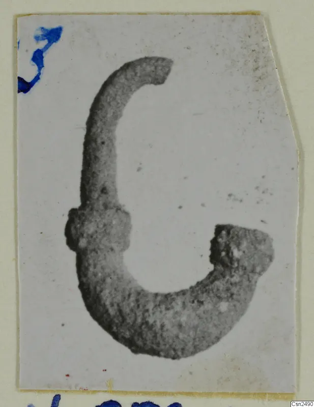 Silver object from Vouni, a curved metal piece with a knobbed end