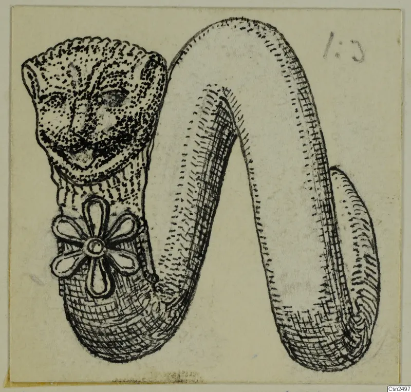 Ink drawing of a silver object with a stippled face at one end and a flower-shaped rosette on its body