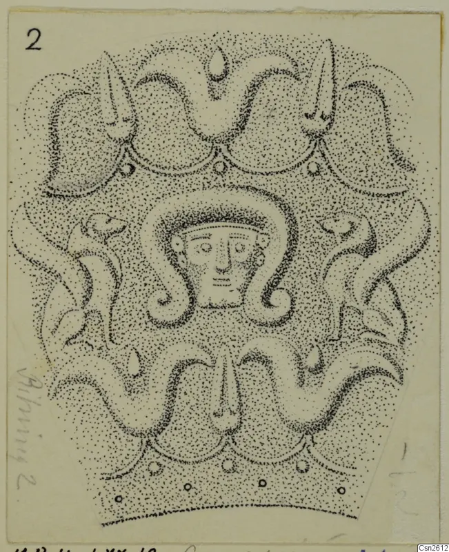 Stippled drawing of a decorated object with a human face framed by curling scroll forms