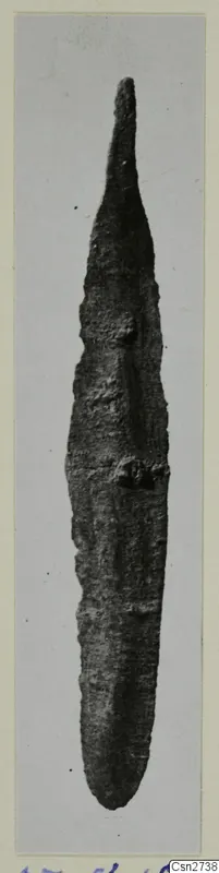 Corroded metal knife blade with a pointed tip, from Ayios Iakovos, photographed on a card mount