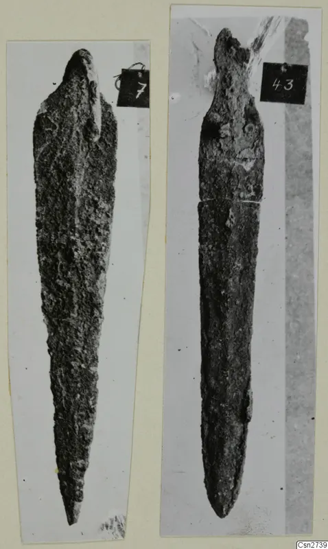 Two corroded bronze tools, each photographed separately and mounted side by side on a card.