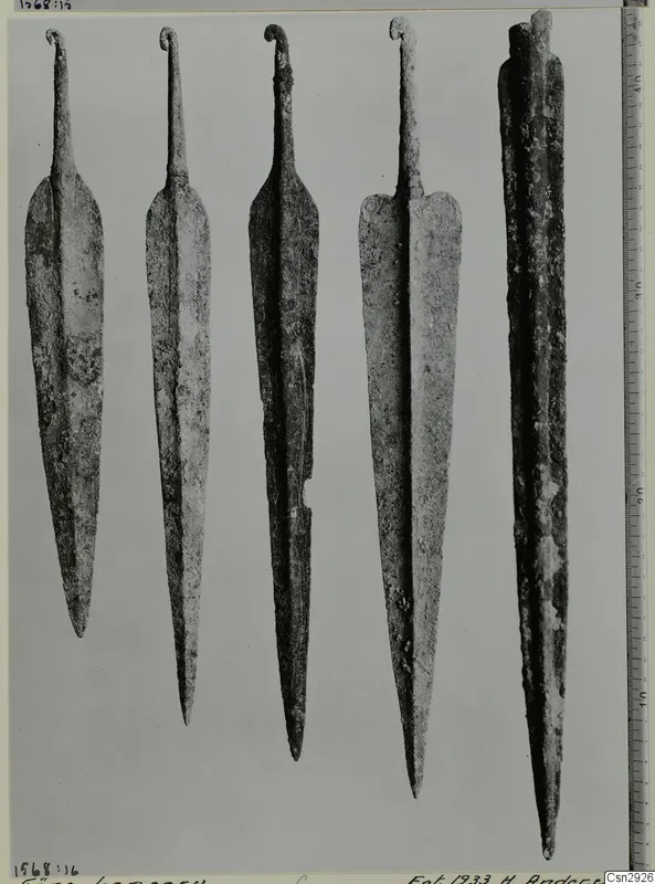 Five corroded metal points with curled tangs, shown side by side before conservation