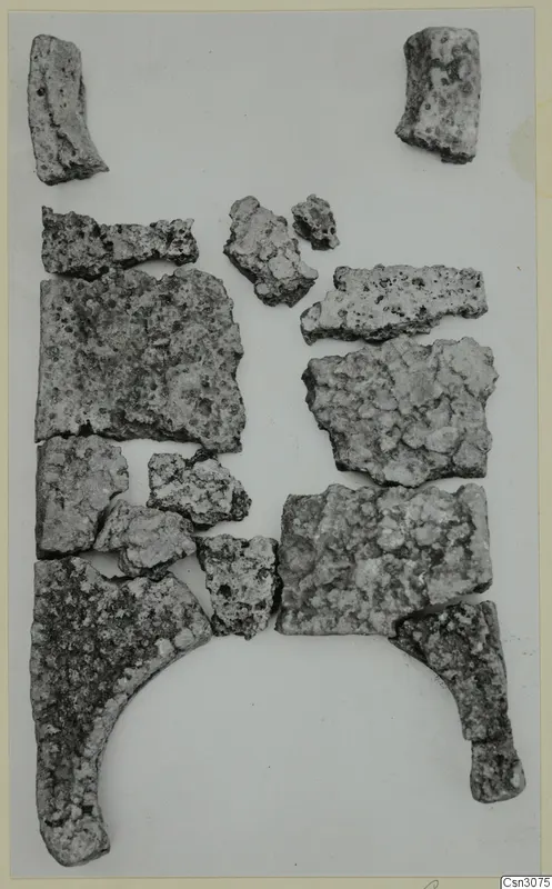 Fragments of a bronze ingot from Mathiati, laid out on a pale surface
