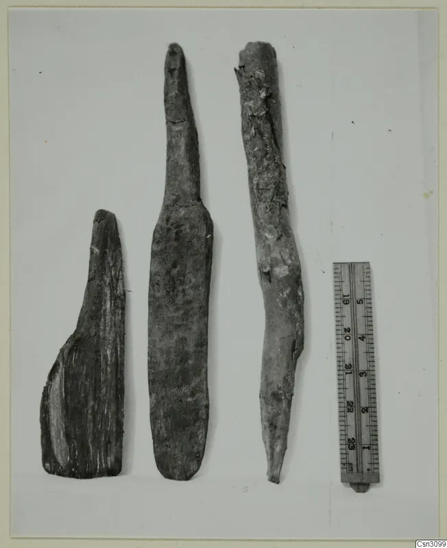 Three wooden tool pieces beside a ruler, from Cypriote mining