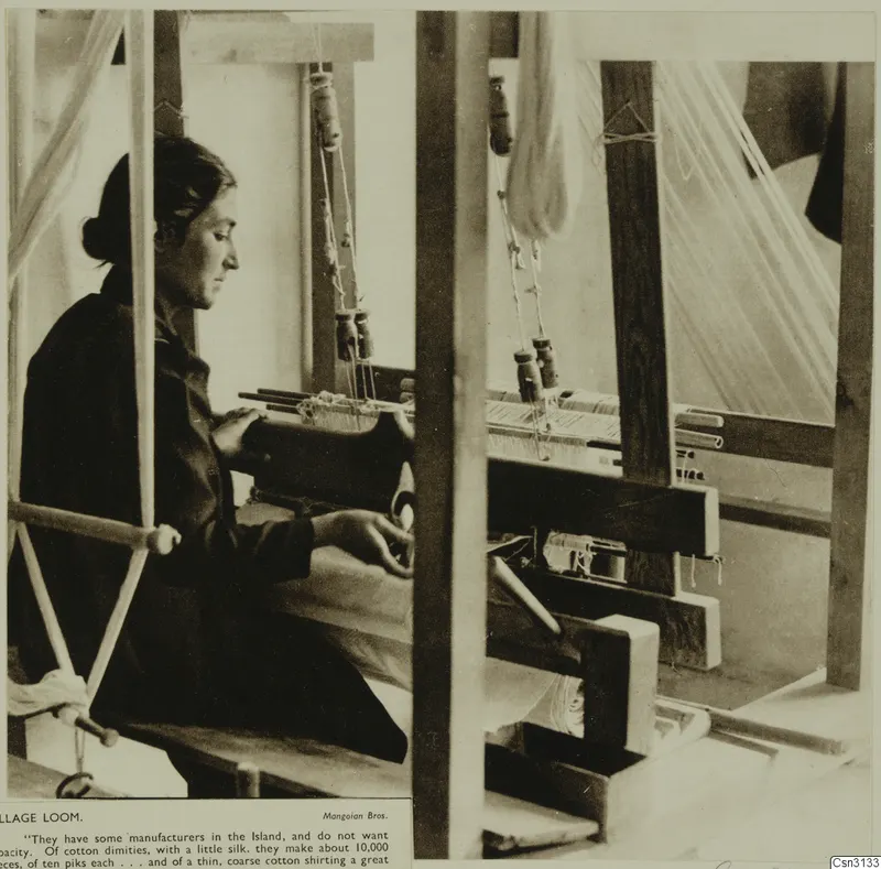 Woman seated at a wooden village loom, working the threads, seen from the side