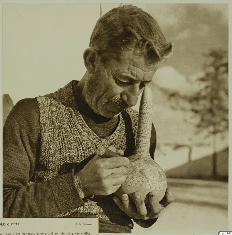 Man carving incised patterns into a long-necked gourd with a small tool
