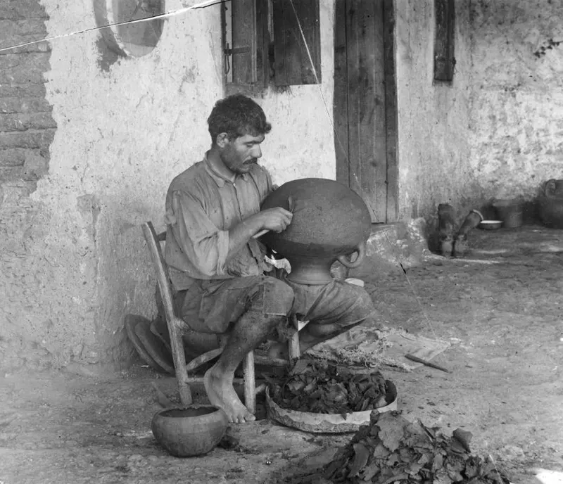 Man shaping a large vessel with a wooden knife at Klirou, farmstead F