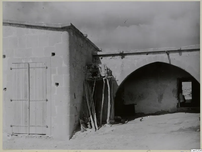 Dovecote at Galinoporni: a stone building with a wooden double door and a large arched vault