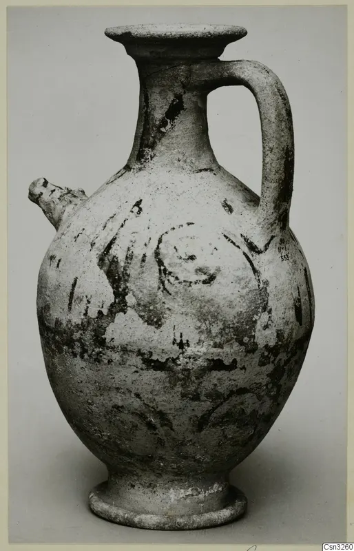 White Painted pottery jug with a side spout, strap handle and dark painted bands and spiral motifs