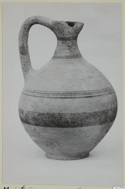White Painted V jug with a single loop handle, a narrow neck and dark painted bands around the body