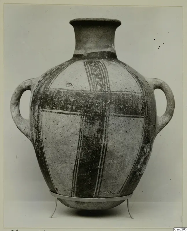 Two-handled White Painted pottery jar with a tall flaring neck and dark painted bands, standing on a metal stand