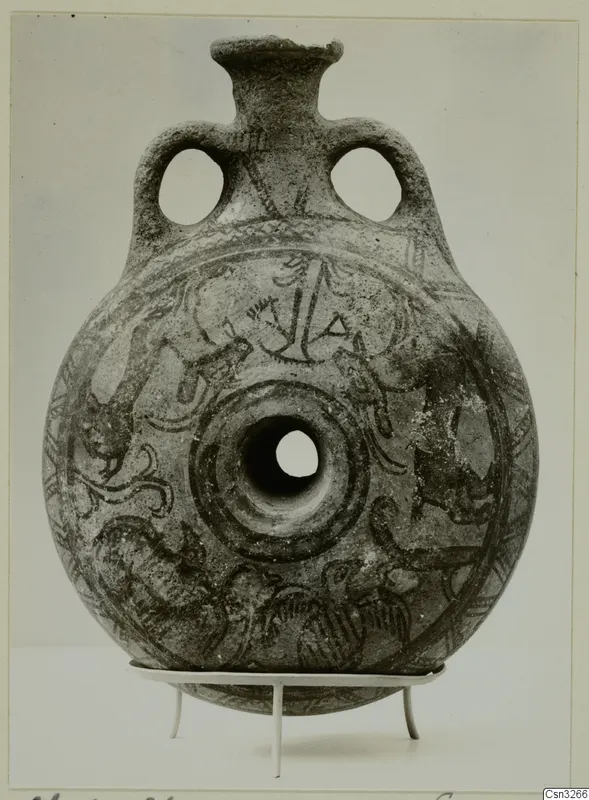 White Painted IV-V vessel: round flattened body with two loop handles and dark painted decoration, on a metal stand