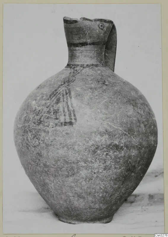 Pottery White Painted III-1 jug with a tall neck, strap handle, painted bands and a motif on the body