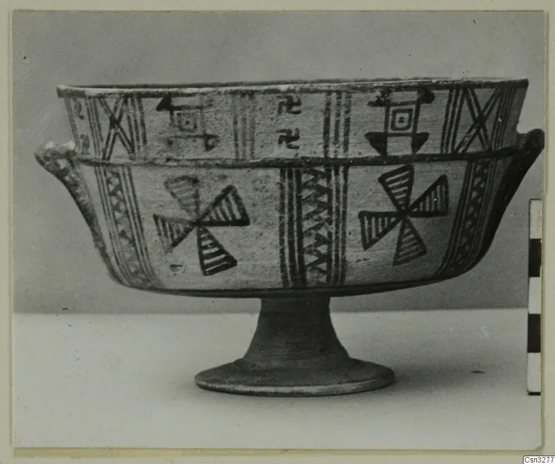 White Painted III-1 footed bowl with dark painted geometric bands and pinwheel motifs