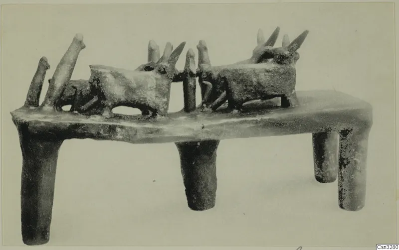 Terracotta stand on four tubular legs, carrying two horned animal figures and several upright pegs