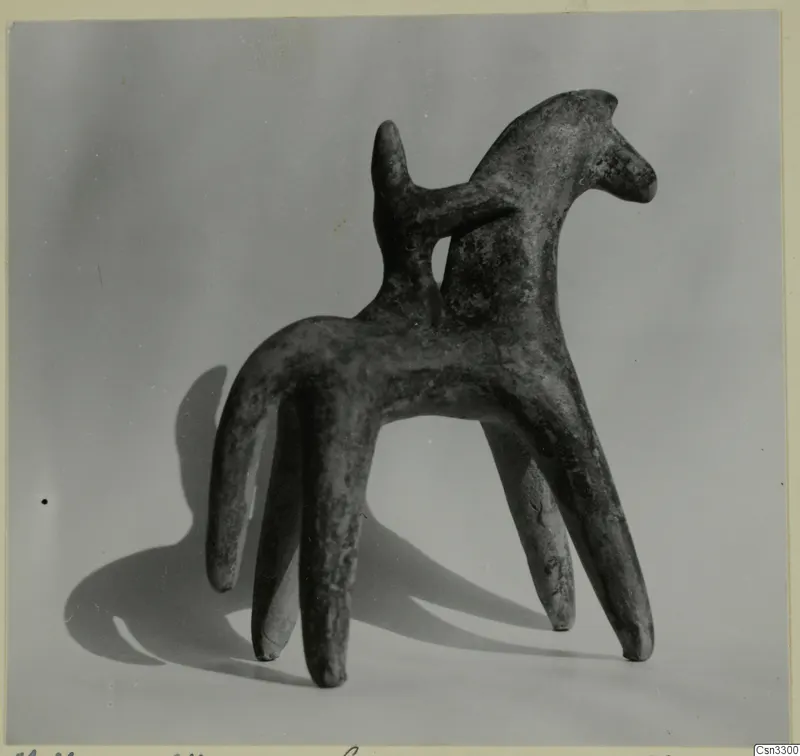Terracotta figurine of an animal with four long legs and a raised head