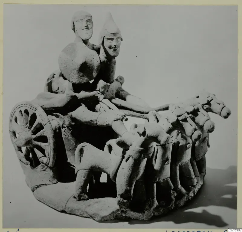 Terracotta model of a chariot with two standing figures, a spoked wheel and a team of horses