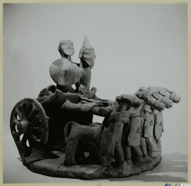 Terracotta model of a two-wheeled chariot carrying two standing figures, drawn by a team of animals