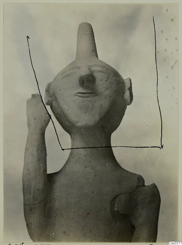Terracotta statuette from Ayia Irini, front view of head and upper body with one arm raised