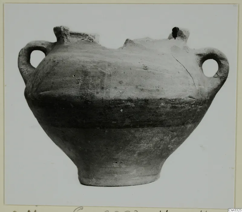 Wheel-made pottery vessel with two loop handles and a broken rim, from Milia