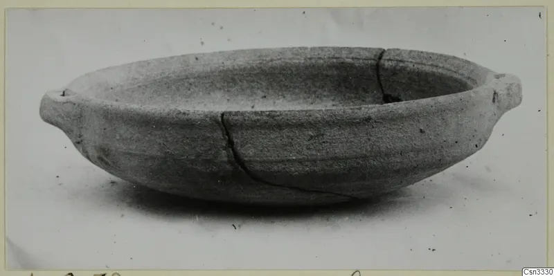 Shallow pottery bowl with two small lug handles and a crack, from Amathus tombs 1–9