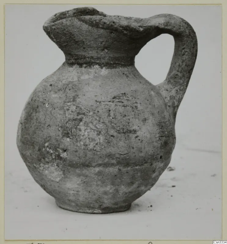 Pottery juglet, White Painted IV, with a rounded body and strap handle
