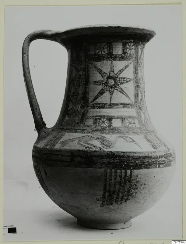 Wheel-made bichrome pottery jug with a star motif in a panel on the neck