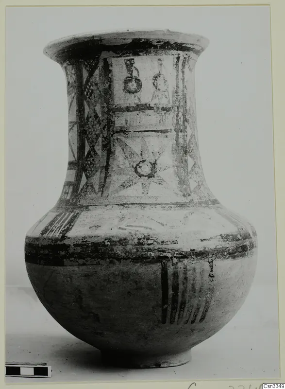 Bichrome wheel-made pottery jar with a flaring rim and painted geometric designs
