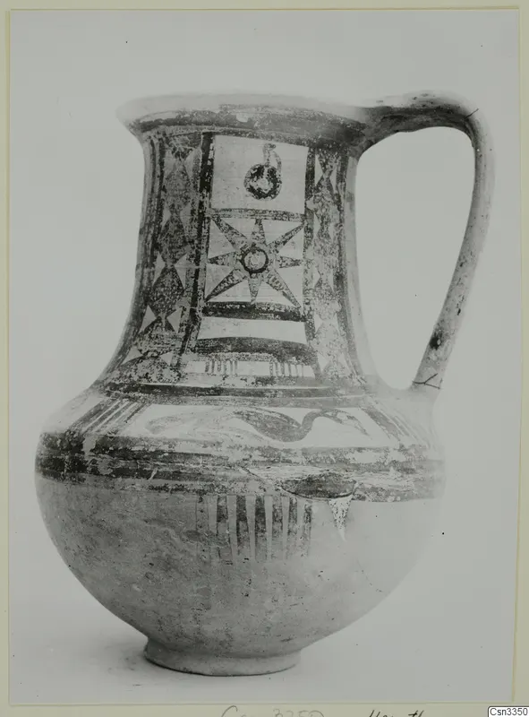 Bichrome wheel-made jug with a strap handle, painted with star and panel motifs on the neck and shoulder