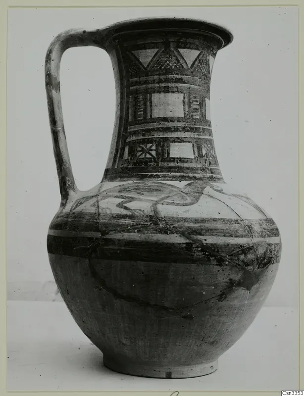 Painted pottery jug with a strap handle and geometric panels on its neck
