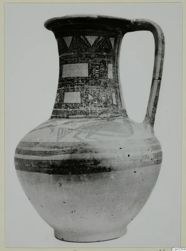 Wheel-made bichrome jug with painted bands and geometric patterns on the neck