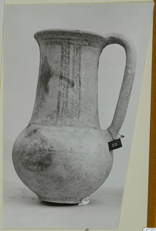 Wheel-made bichrome pottery jug from Enkomi, with dark painted vertical bands on the neck and a strap handle