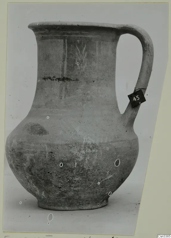 Pottery jug with a flared rim and strap handle, Bichrome Wheel-made