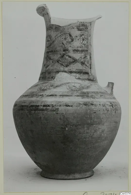 Bichrome pottery jug, wheel-made, with painted bands and rosette motifs on the neck.