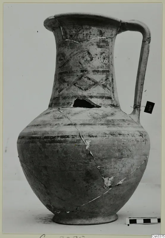Bichrome wheel-made jug with a strap handle and dark painted bands and motifs
