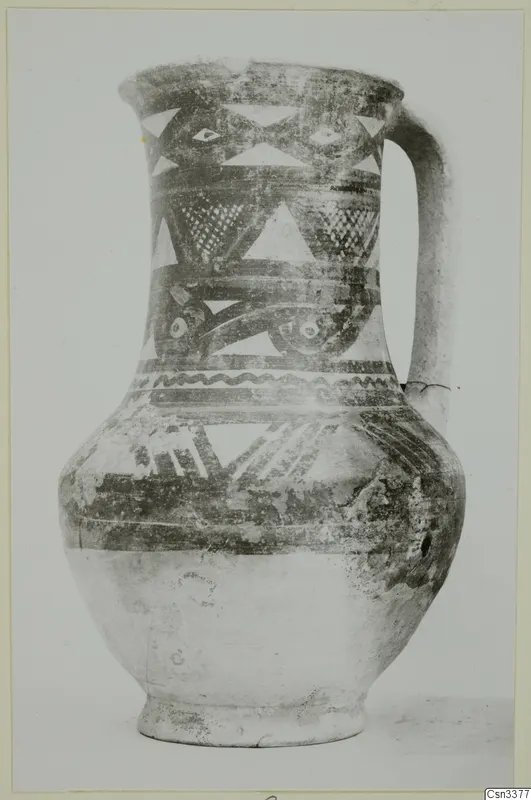 Bichrome wheel-made jug with a strap handle, dark bands and light painted triangles on the upper body