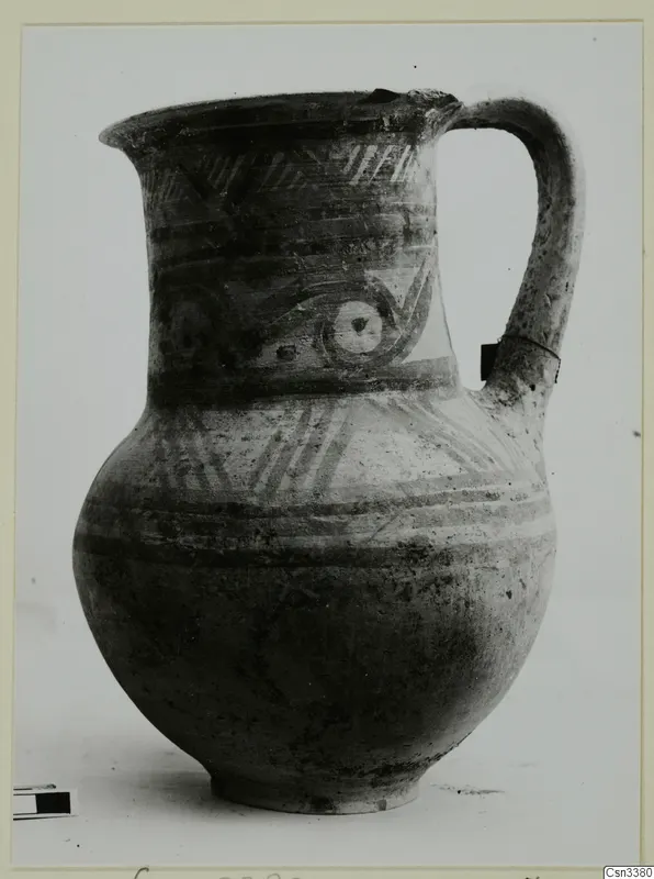 Painted jug with a loop handle, horizontal bands, hatched motifs and concentric circles on the neck