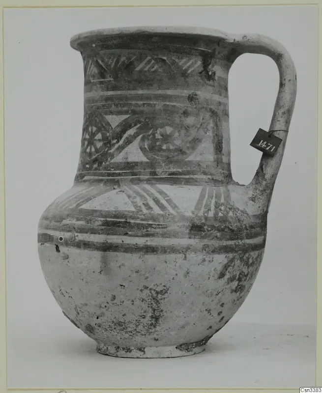 Painted jug with a loop handle, a tall neck and bands of pattern, shown against a plain background.