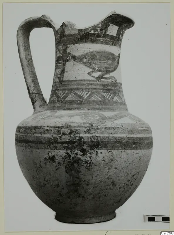 Bichrome wheel-made pottery jug with a strap handle and painted bands, with a bird-like motif on the neck