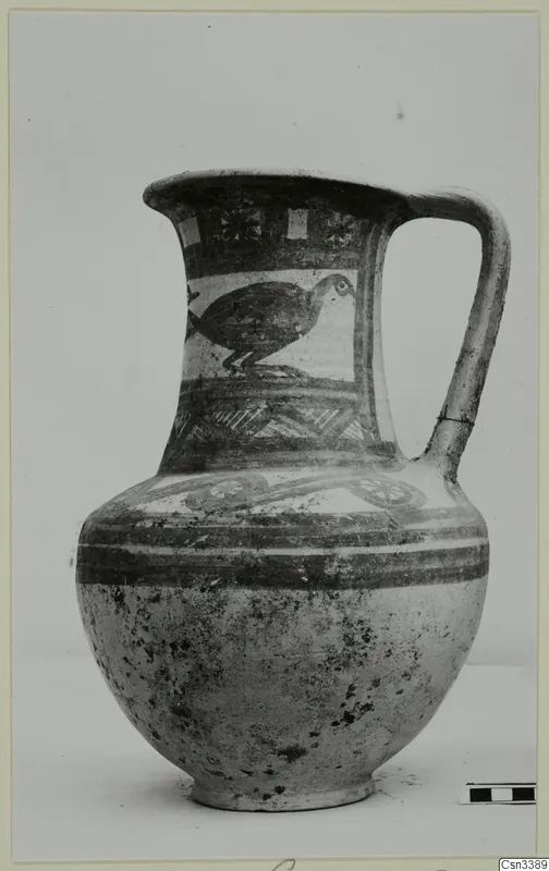 Bichrome wheel-made jug with a painted bird and bands of ornament.
