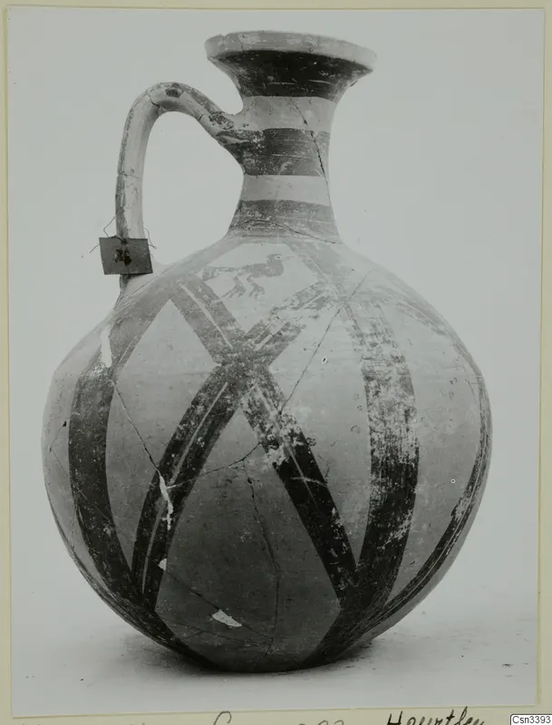 Jug with a loop handle and dark painted bands and diagonal stripes, from Milia.